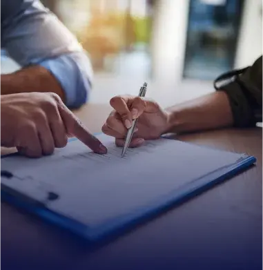 Roofing contractor and homeowner reviewing a roof insurance claim document together in St. Louis County