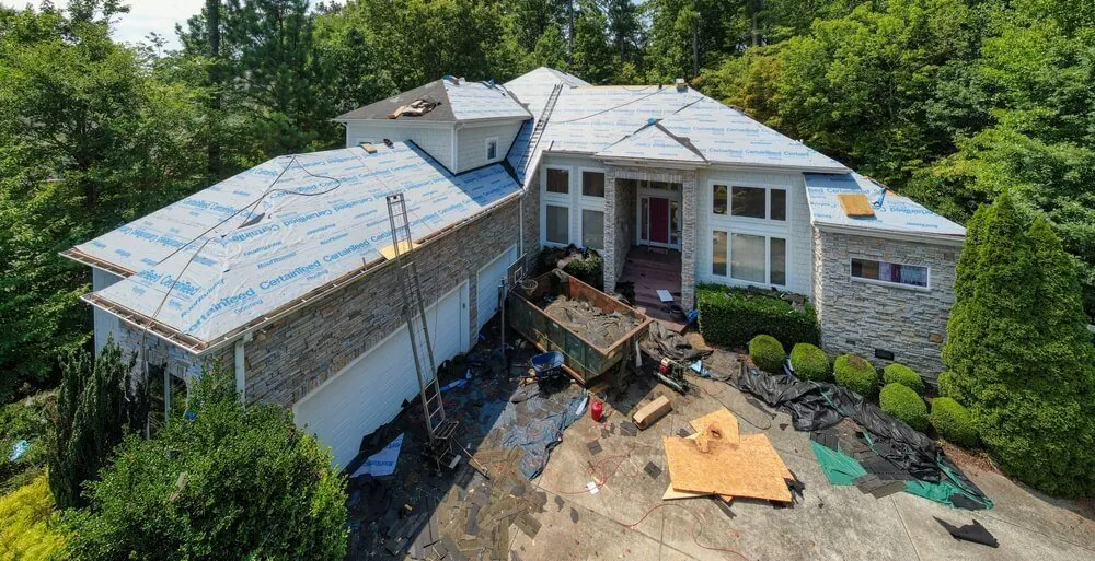 Aerial view of house during roof replacement — Brandon J Roofing South County